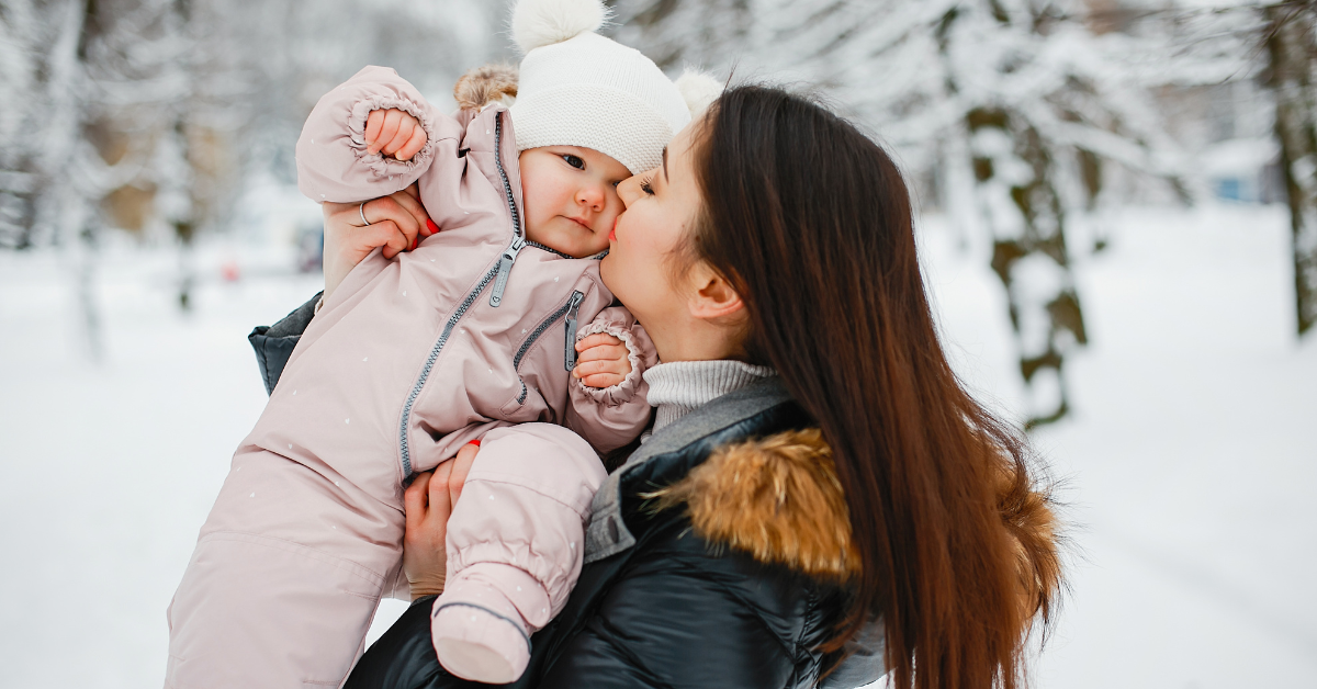 Baby girl and mum in the snow